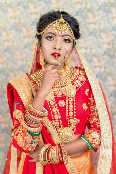 Portrait of Indian Bride in gold and diamond jewelry and wearing red saree
